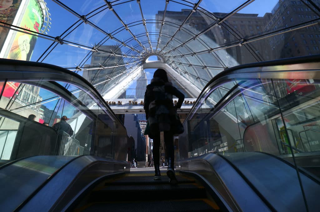A person rides an escalator in front of the Empire State Building at the new entrance to Penn Station and the Moynihan Train Hall, as seen in January 2021 in New York City. (Photo by Gary Hershorn/Getty Images)